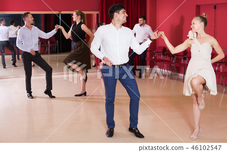 Laughing group people dancing lindy hop in pairs 46102547