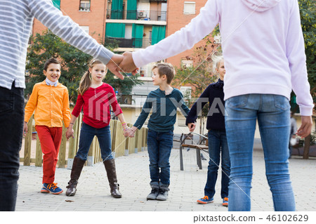 Group of cheerful children playing red rover Group of cheerful children playing red rover 46102629