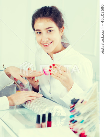 Woman doing manicure Woman doing manicure 46102690