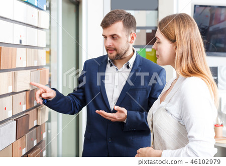 Young girl consulting with salesman Young girl consulting with salesman 46102979