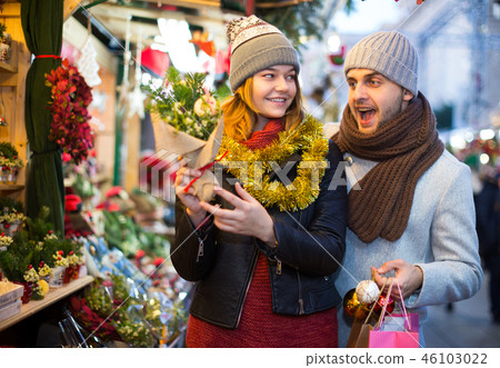 Woman and man choosing decorations and Christmas tree 46103022
