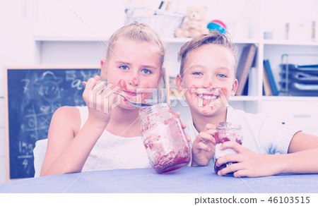 Portrait of sister with brother who are eating jam at time lunch 46103515