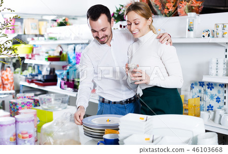Couple selecting crockery in store 46103668