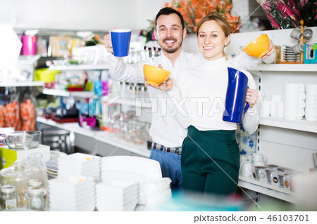 Couple selecting crockery in store Couple selecting crockery in store 46103701