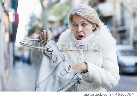 Adult female is having problem because her wallet was stolen Adult female is having problem because her wallet was stolen 46103704