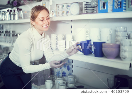 Woman choosing crockery in store Woman choosing crockery in store 46103709