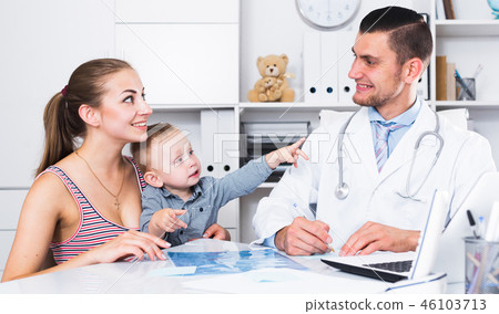 Man medical worker talking with young mother Man medical worker talking with young mother 46103713