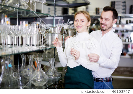 Couple choosing new wine glasses 46103747