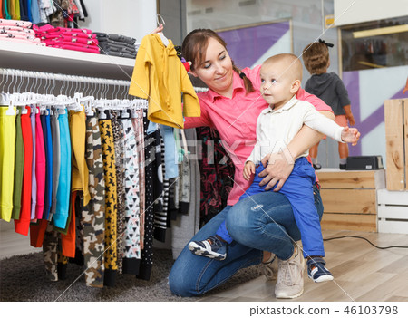 mother with kid is looking clothes mother with kid is looking clothes 46103798