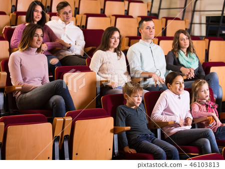 A group of people attentively watching a movie 46103813