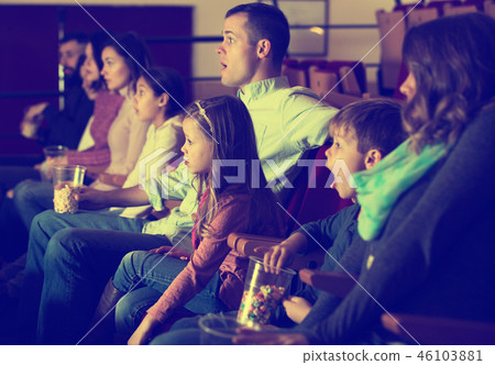 Group of people watching exciting movie Group of people watching exciting movie 46103881