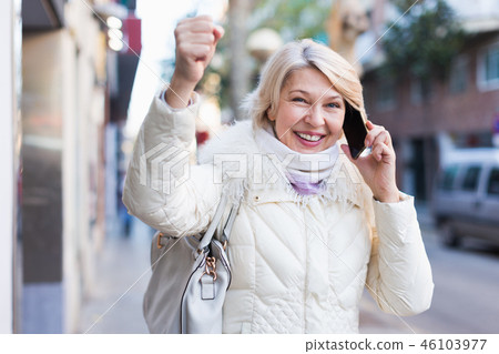 Happy female raise hand up and talking on phone Happy female raise hand up and talking on phone 46103977