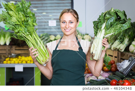 woman selling fresh greens on market . woman selling fresh greens on market . 46104348