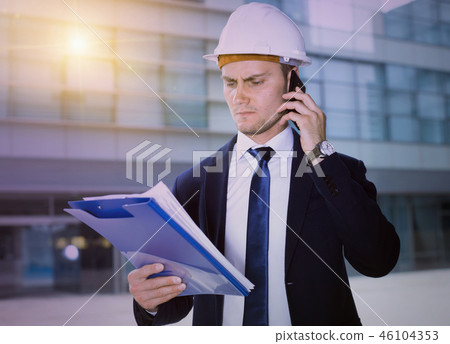 Architector in suit and hat is taking folder and discussing proj Architector in suit and hat is taking folder and discussing proj 46104353
