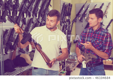 Friends choosing air-powered gun Friends choosing air-powered gun 46104684
