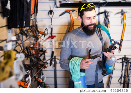 Man choosing climbing equipment 46104826
