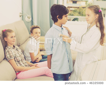 Medic girl with stethoscope at home Medic girl with stethoscope at home 46105000
