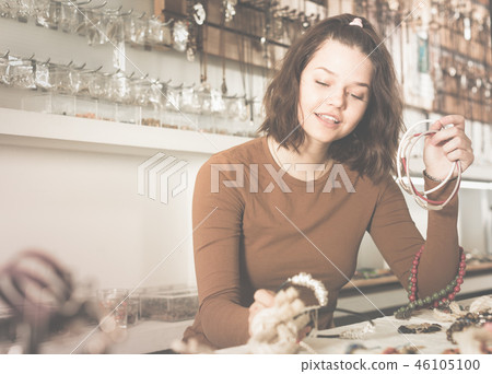Woman showing different pendant Woman showing different pendant 46105100