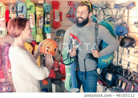 Couple deciding on climbing equipment Couple deciding on climbing equipment 46105112