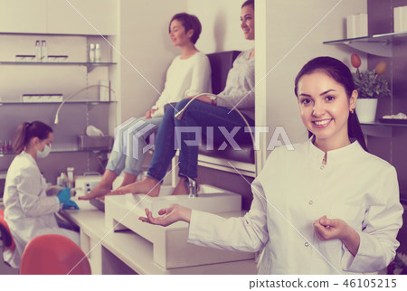 Young nail salon master inviting clients to procedure Young nail salon master inviting clients to procedure 46105215
