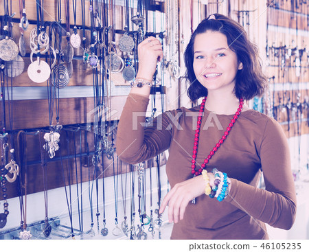 Girl seller offering fashionable bracelets and pendants Girl seller offering fashionable bracelets and pendants 46105235