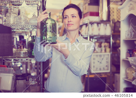 woman chooses glass decorative bottles woman chooses glass decorative bottles 46105814
