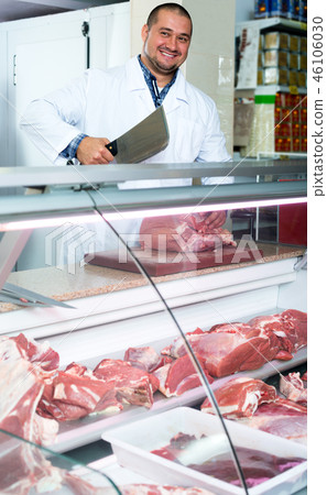 Male butcher in kosher section at supermarket Male butcher in kosher section at supermarket 46106030