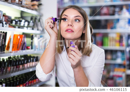 Woman testing mascara in store 46106115