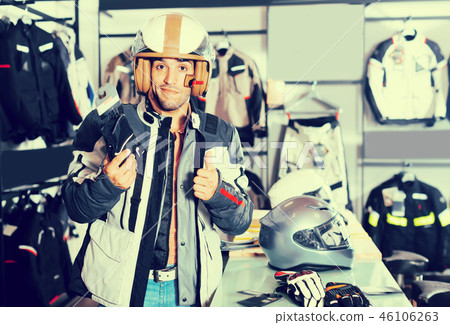 Happy man is choosing new gloves Happy man is choosing new gloves 46106263