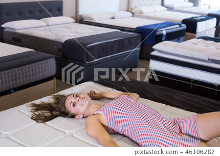 woman testing a commodious mattress woman testing a commodious mattress 46106287