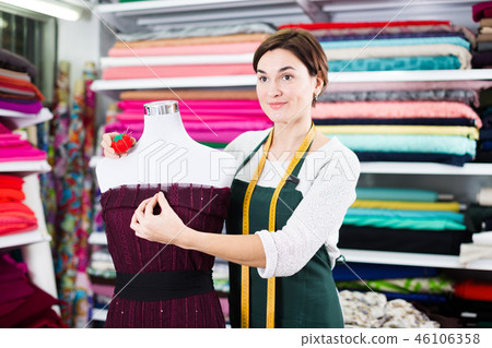 Tailor working at dress 46106358