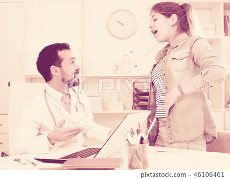 Doctor and girl with pain in side 46106401