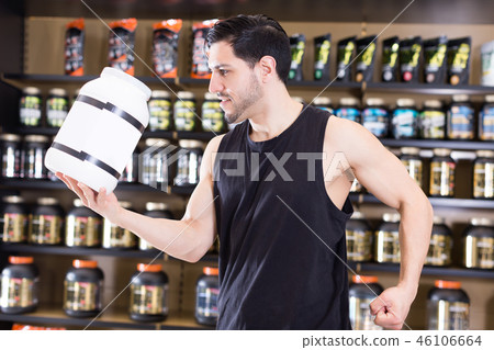 man showing muscles and sport nutrition man showing muscles and sport nutrition 46106664
