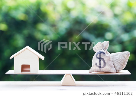 Balance a money bag and small residential. Balance a money bag and small residential. 46111162