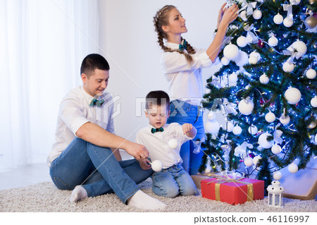 mom dad and son decorate Christmas tree gifts new year tree winter holiday Garland 46116997