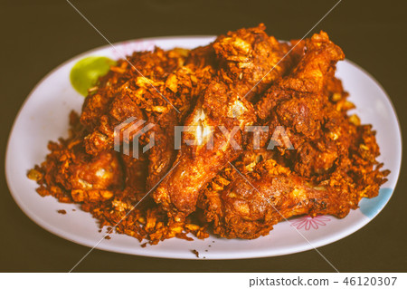 Hot and crispy fried chicken legs, thai style. 46120307