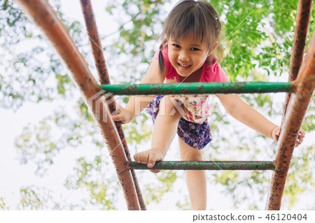 Happy kid playing in the playground Happy kid playing in the playground 46120404