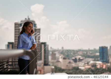 Young office woman talking by phone outdoors 46123144