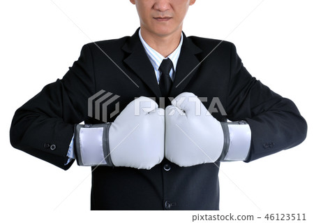 Businessman wearing boxing gloves acting punching. Businessman wearing boxing gloves acting punching. 46123511