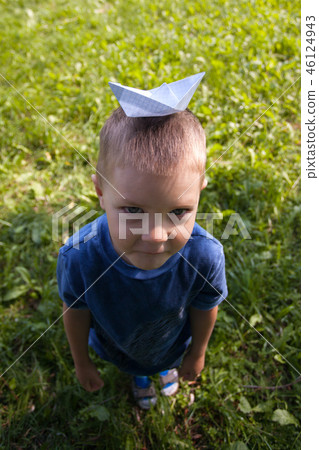 Happy laughing child play with paper ship indoors Happy laughing child play with paper ship indoors 46124943