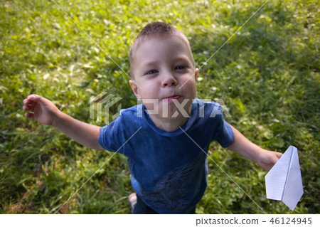 Boy 4 years old, under the green grass in summer  46124945