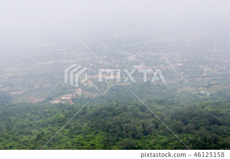 Countryside village is covered with the fog. 46125158