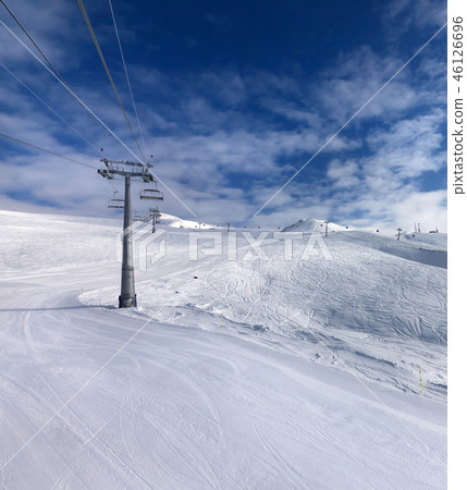 Ski slope, chair-lift on ski resort and blue sky 46126696
