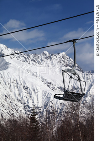 Ski-lift on ski resort and snowy mountains Ski-lift on ski resort and snowy mountains 46126719