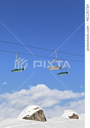 Sunlight chair-lift and blue sky with clouds  46126784