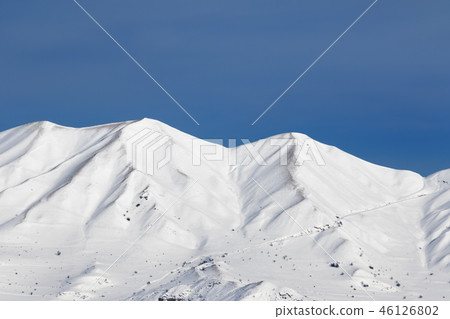 Snowy winter mountains and blue clear sky 46126802