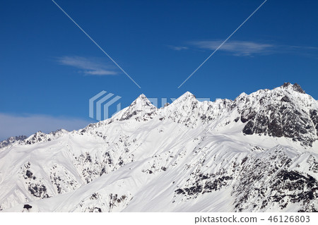 Rocky peaks of mountain in snow 46126803