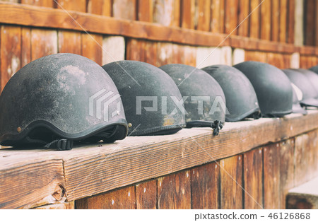 horse helmets in a line waiting to be used 46126868