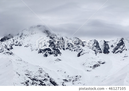 Mountains in snow and cloudy sky before snowfall Mountains in snow and cloudy sky before snowfall 46127105