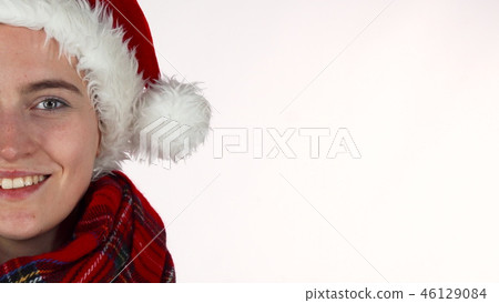 Happy Christmas girl in Santa Claus hat and scarf laughing to the camera 46129084